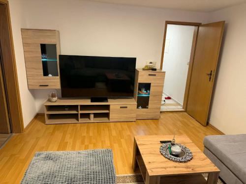 a living room with a large flat screen tv at Guest House Harmony in Lutherstadt Eisleben