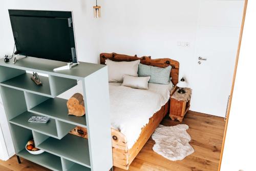 a bedroom with a bed and a mirror at Seetraum Steffi in Zoznegg