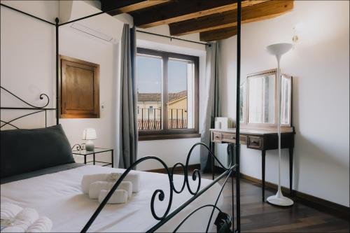 a bedroom with a bed and a window at Cavour Luxury Apartments in Verona