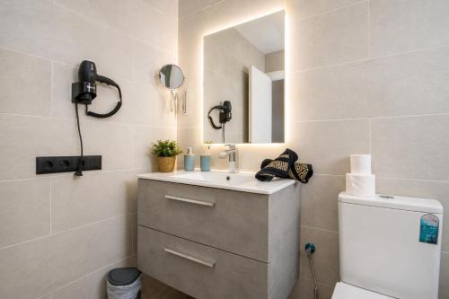 a bathroom with a sink and a mirror at Apartamento Alba Lanzarote in Puerto del Carmen