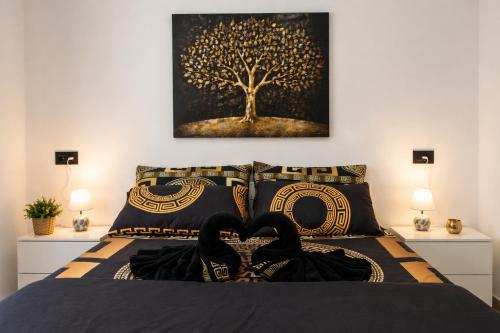 a bedroom with a bed with a picture of a tree at Apartamento Alba Lanzarote in Puerto del Carmen
