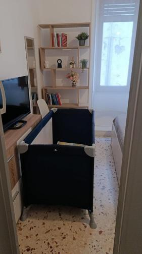 a living room with a desk and a television at My tiny house in Salerno