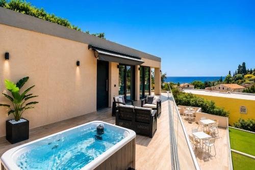 a hot tub on the deck of a house at Nobile Boutique Hotel in Agios Gordios