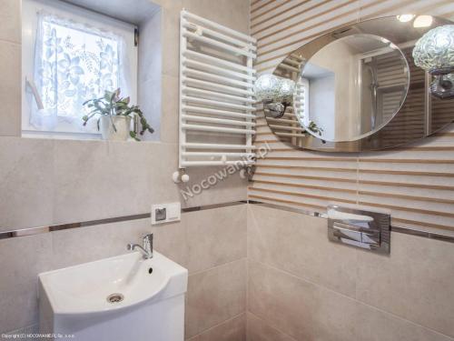 a bathroom with a sink and a mirror at Pokój 2-osobowy in Węgorzewo