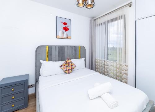 a bedroom with a white bed and a window at Snyder luxe homes 1 in Tatu City