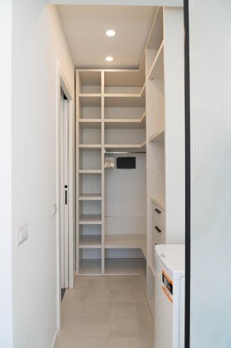 a walk in closet with white walls and shelves at La Casetta di Carol in Capri