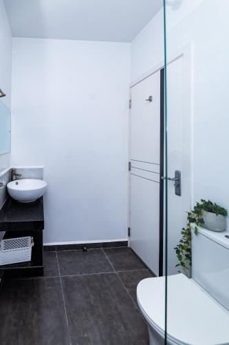 a white bathroom with a toilet and a sink at Snyder luxe homes 1 in Tatu City