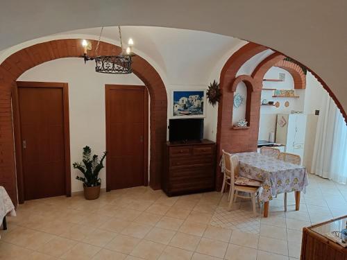 a dining room with a table and a television at Il Raggio in Capri
