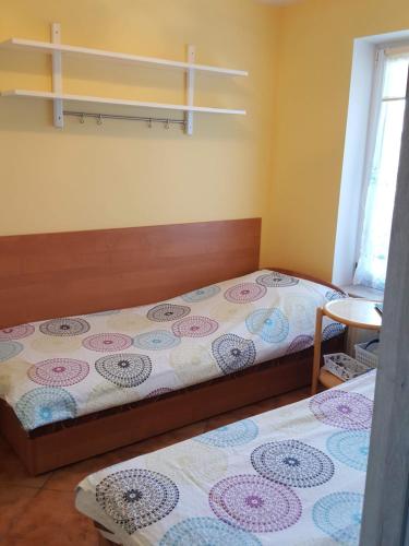 a bedroom with two beds and a window at Pokój 2-osobowy in Węgorzewo