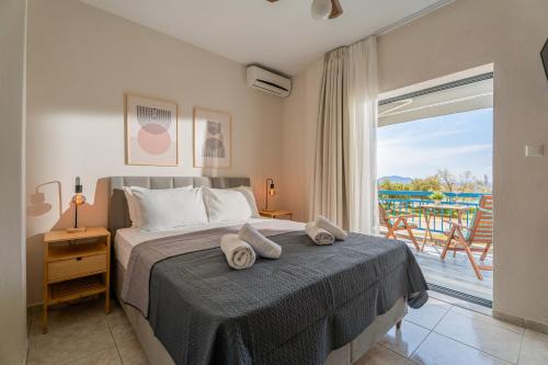 a bedroom with a bed with towels on it at Orion 2 in Neos Marmaras
