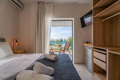 a bedroom with a bed and a view of a patio at Orion 2 in Neos Marmaras