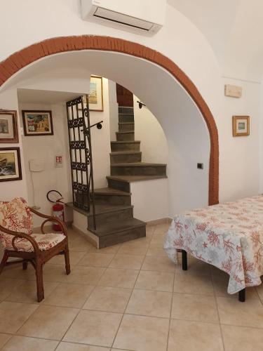 a room with a staircase and a table and a chair at Il Raggio in Capri