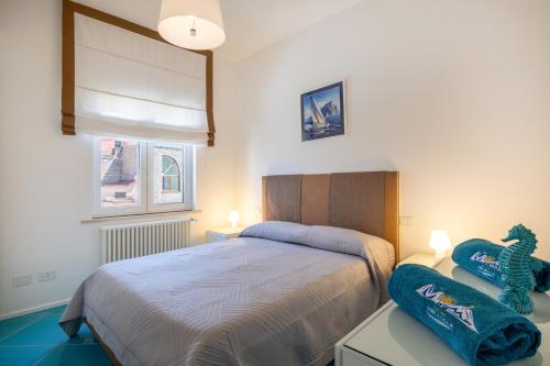 a bedroom with a bed and a table with a stuffed animal at Relais Miramar in Termini