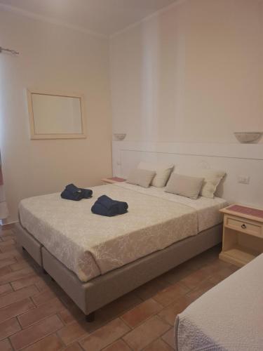 a bedroom with a bed with two towels on it at B&B La Pavoncella in San Teodoro