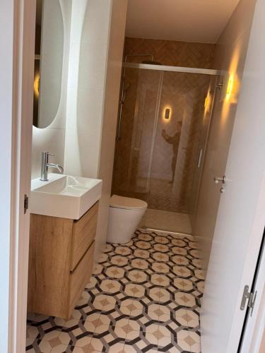 a bathroom with a sink and a shower at Pension Nagusia in Basauri