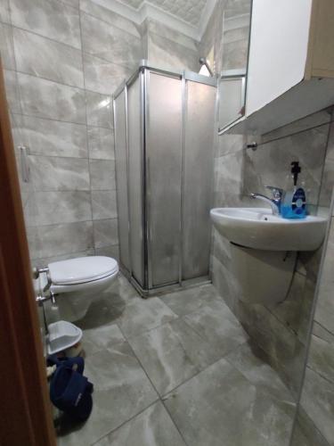 a bathroom with a toilet and a sink and a shower at Can Residence in Trabzon