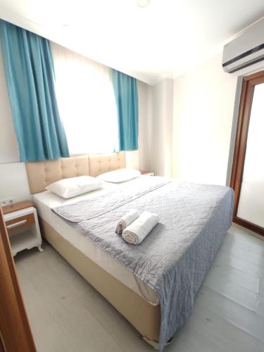 a bedroom with a bed with two towels on it at Can Residence in Trabzon