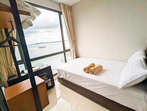 a bedroom with a bed with two towels on it at Lovina 5-AA at One Residence in Batam Center