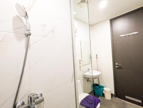 a bathroom with a shower and a toilet at Lovina 5-AA at One Residence in Batam Center