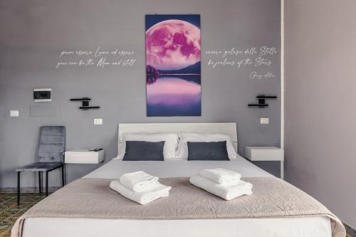 a bedroom with a large bed with two pillows on it at Malù House in Fiumicino