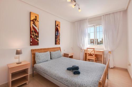 a bedroom with a bed with a teddy bear on it at Casa Orquídea 7 in El Médano