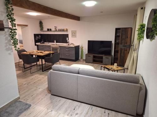 a living room with a couch and a table at Zum Feriennest in Ochtendung