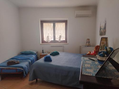 a bedroom with two beds and a window at Casa dell'orso in Rocca di Botte