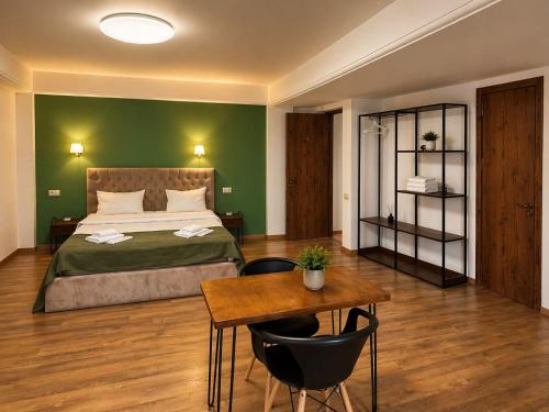 a bedroom with a bed and a table with chairs at BB Old City in Tbilisi City