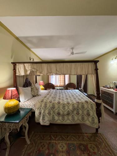 a bedroom with a bed with a canopy at Navya Niwas - The Rooms in Dehradun