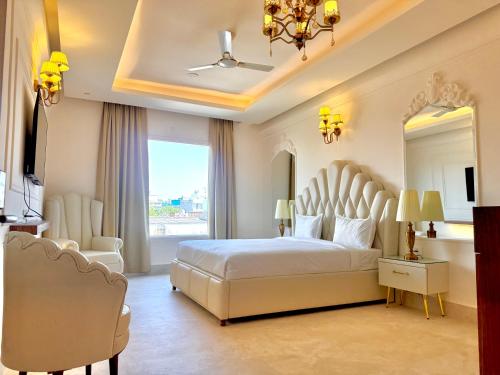 a bedroom with a large bed and a large window at The Arte in Rohtak