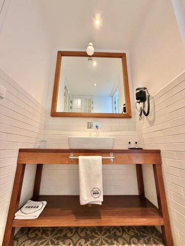 a bathroom with a sink and a mirror at Grand Hotel Urban in Antananarivo