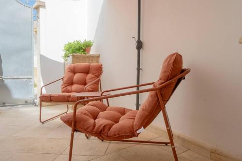 a couple of chairs sitting in a room at Galati House in Melendugno