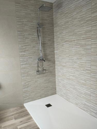 a shower with a glass door in a bathroom at Casa Camiño dos Faros in Sinde
