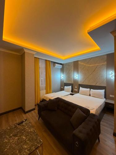 a hotel room with a bed and a couch at Royal Nest in Istanbul