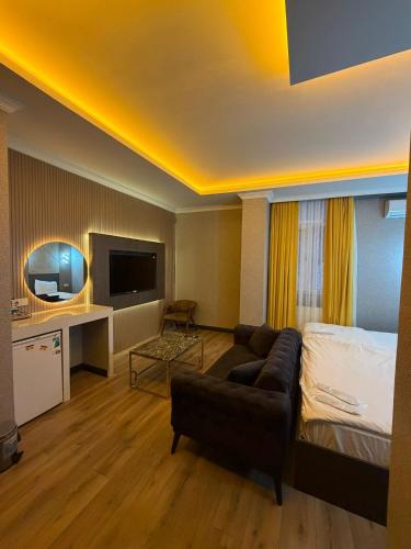 a hotel room with a bed and a couch at Royal Nest in Istanbul