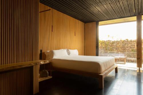 a bedroom with a bed and a large window at Belle Torre Mayorazgo Boutique Hotel in Villatoro
