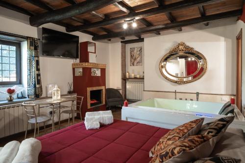 a bathroom with a tub and a table and a mirror at Golden House in Bracciano