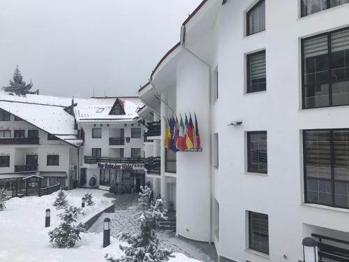 a view of the courtyard of a building in the snow at Hotel Miruna - New Belvedere in Poiana Brasov