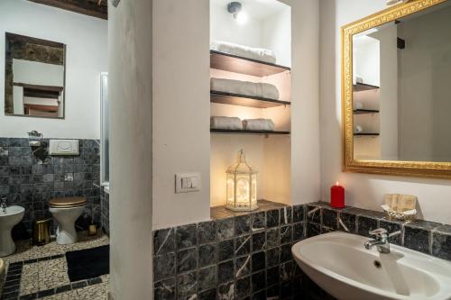 a bathroom with a sink and a mirror at Golden House in Bracciano