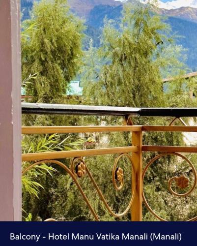 a view of a mountain from a balcony with a bike at Hotel Royal Selection in Manāli