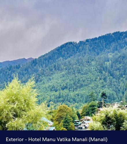 a view of a mountain with trees at Hotel Royal Selection in Manāli