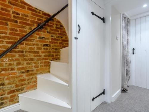 a brick wall and stairs in a house at 3 Bed in Matlock oc-78591 in Cromford