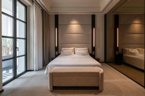 a bedroom with a large bed and two windows at Sparano Palace - Luxury Maison in Bari