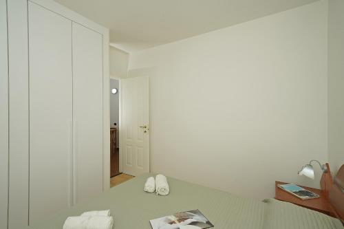 a bedroom with a bed with two white shoes on it at Casa vacanza Iris in Toscolano Maderno
