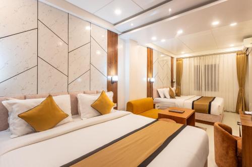 a hotel room with a bed and a desk at Accom Hotel in Ilām