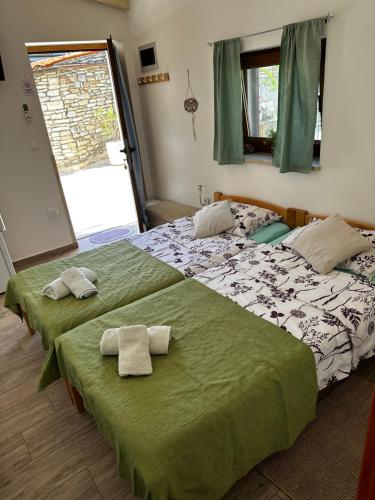 two beds in a bedroom with towels on them at Casa Borgo in Bale
