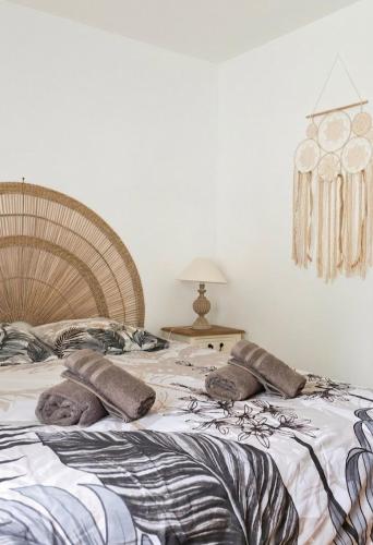a bedroom with a large bed with pillows on it at Penty horizon de Brocéliande in Augan