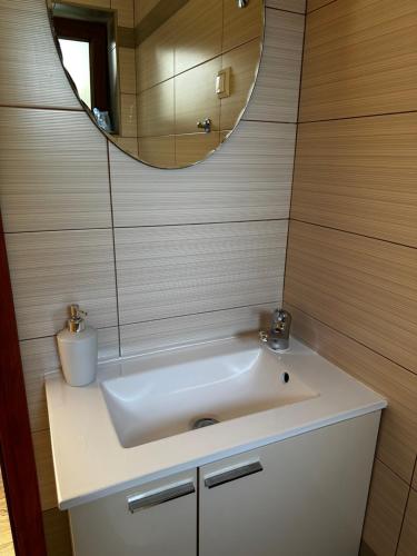 a bathroom with a white sink and a mirror at Casa Borgo in Bale