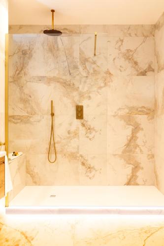 a bathroom with a large shower with a tub at Woodford Dolmen Hotel Carlow in Carlow