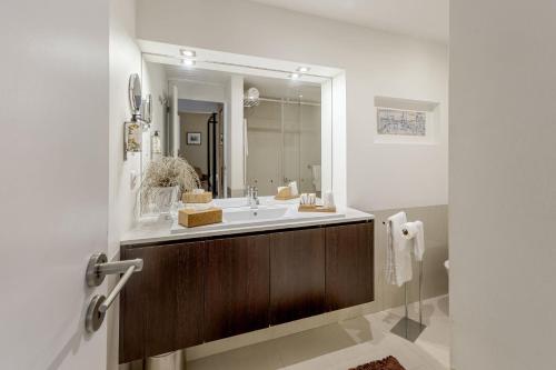 a bathroom with a sink and a mirror at Casas do Porto - Ribeira Apartments in Porto